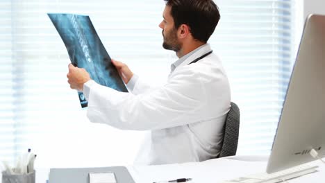 Male-doctor-examining-x-ray