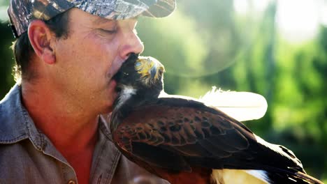 Man-kissing-falcon-on-a-sunny-day