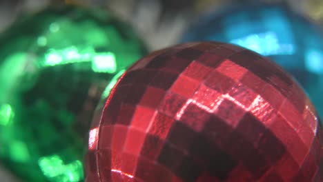 Dreamy-Christmas-holiday-decoration,-colorful-crystal-ornaments-colorful-balls-on-a-360-rotating-stand-new-year-decorated,-shiny-lights,-cinematic-Macro-tilt-down-4K-video,-beautiful-depth-of-field