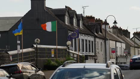 Main-Street,-Claremorris,-County-Mayo:-featuring-Ukrainian,-Irish,-and-European-flags