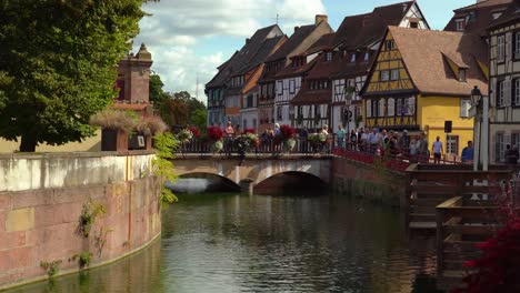 Man-Looks-Around-While-Standing-on-a-Bridge-in-Fishmongers-district-in-Colmar