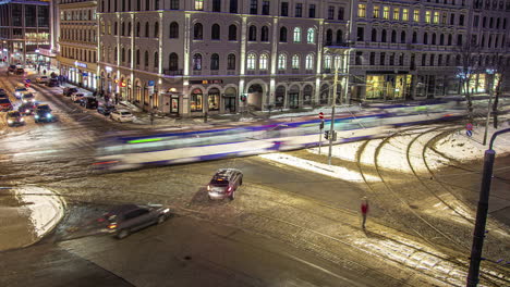 Time-lapse-main-intersection-at-night-during-winter-snow-on-ground,-Riga-Latvia