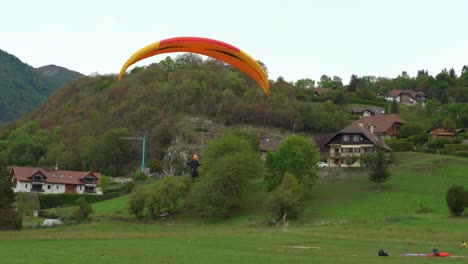 Paraglider-Lands-in-the-Field-near-the-Lake-Annecy
