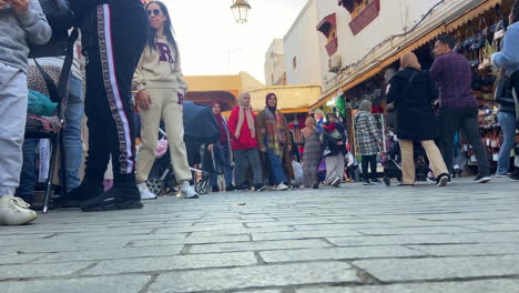 Crowd-of-Moroccan-people-walking-in-muslim-street-bazaar-at-day-time