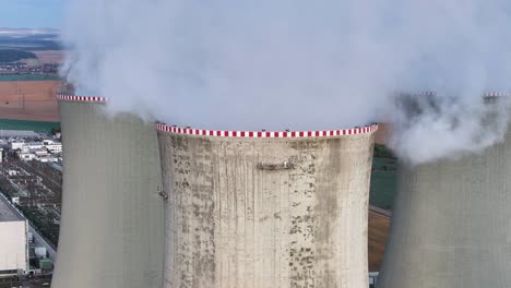 Aerial-ascend-near-nuclear-power-plant-cooling-towers-emit-water-vapor
