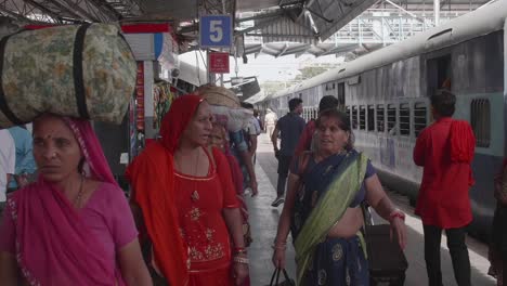 Local-Indian-people-walking-along-train-station-platform