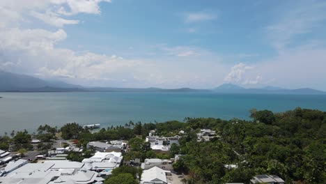 Revealing-drone-view-over-the-Australian-town-of-Port-Douglas-looking-towards-the-Daintree-Rainforest-in-the-distance
