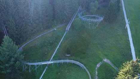 rising-up-Drone-shot-of-bobsleigh-on-wheels-being-transported-to-start-of-the-race