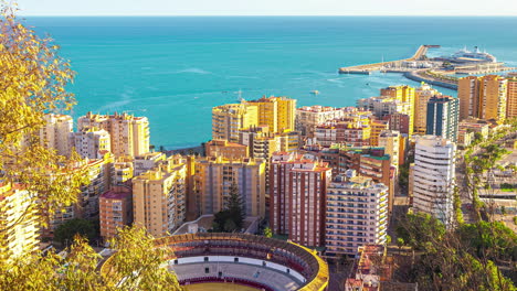 Time-lapse-looking-over-the-Malaga,-Spain-downtown-area-prominently-featuring-the-famous-Plaza-de-Toros-bullring