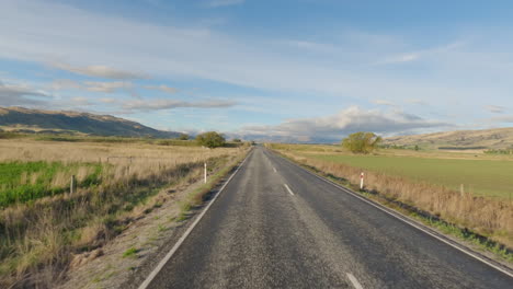 Driving-On-Country-Road-Through-Fields-In-South-Otago,-New-Zealand