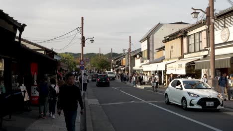 Japanese-People-walking-Street-in-Prefectural-Road-29-in-Arashiyama,-Kyoto-Japan