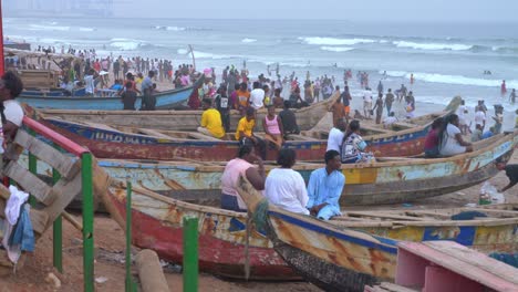 people-gathering-on-the-beach-with-fisherman-boat-and-vendor-seller