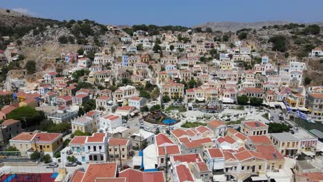 Drone-shot-of-the-colorfull-houses-of-Symi-Island,-Greece