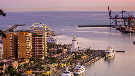 Time-lapse-of-condos-overlooking-the-port-of-Malaga,-Spain-during-sunset