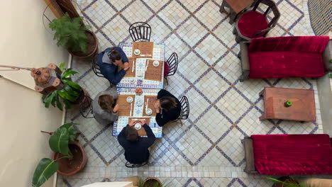 Family-having-breakfast-in-courtyard-of-a-Moroccan-Riad