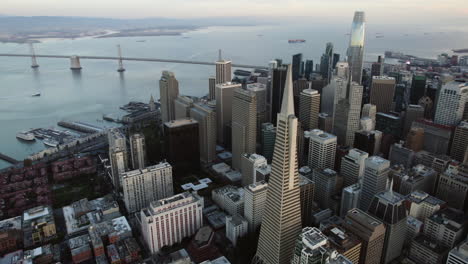 Aerial-view-rotating-in-front-of-the-skyline,-overlooking-the-Embarcadero-port-of-San-Francisco