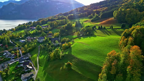 A-Reverse-Shot-Of-A-Small-Village-On-A-Green-Landscape-On-A-Hill-By-The-Lake-In-Austria