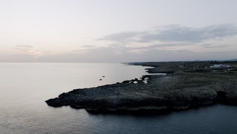 Aerial-footage-in-the-early-morning-light-of-the-coast-of-Polignano-a-Mare,-Italy