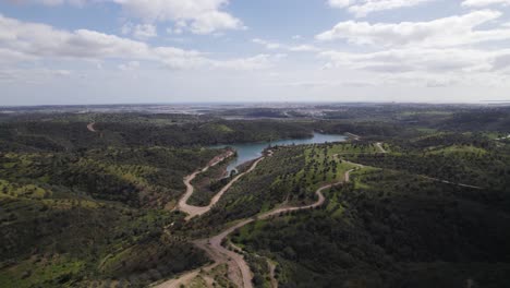 Aerial-wide-view-of-Morgado-de-Arge-Dam-surrounded-by-cultivated-slopes,-Portimão