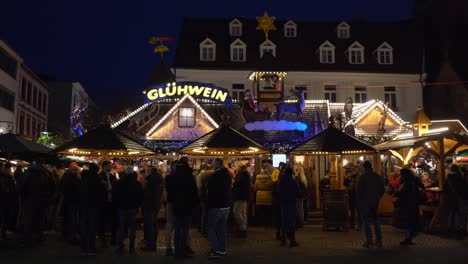 Crowd-of-People-standing-at-Christmas-Market-stall-drinking-mulled-wine