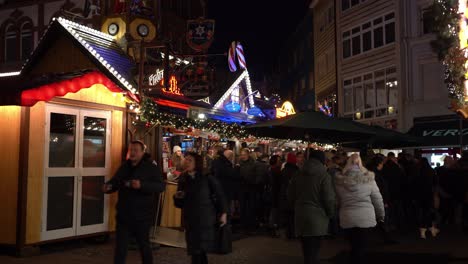 Crowds-of-People-strolling-Christmas-market-streets-at-night