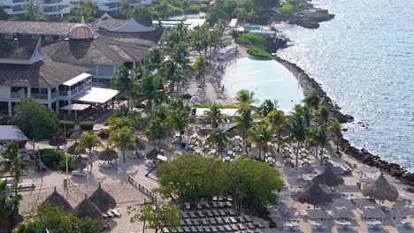 Aerial-parallax-around-saltwater-infinity-pool-overlooking-beautiful-Caribbean-sea
