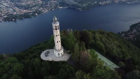 Aerial-of-The-Faro-Voltiano-lighthouse-overlooking-Lake-Como,-Italy
