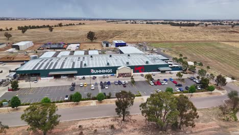 Yarrawonga,-Victoria,-Australia---7-December-2023:-Aerial-sideways-view-of-the-Yarrawonga-Bunnings-hardware-store-with-paddocks-and-airport-beyond