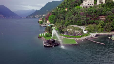 Aerial-toward-the-famous-Lake-Como-Water-Fountain-Villa-Geno,-Italy