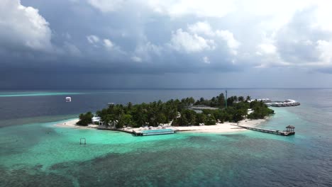 Climbing-aerial-view-of-Bathalaa-island-showing-the-island-and-surrounding-reef,-Maldives,-Indian-Ocean