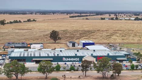 Yarrawonga,-Victoria,-Australia---7-December-2023:-Aerial-reveal-of-the-Bunnings-hardware-store-in-Yarrawonga-with-farm-paddocks-and-Yarrawonga-Airport-beyond