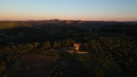 Panoramic-aerial-overview-of-Villa-looking-over-olive-orchard-in-Tuscany-Italy
