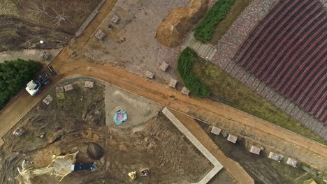 An-Aerial-Shot-Of-A-Construction-Site-And-A-Construction-Vehicle-Moving-On-A-Driveway
