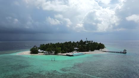 Low-aerial-view-of-Bathalaa-resort-island-showing-the-pier-and-surrounding-reef