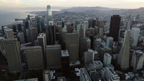 Aerial-view-circling-in-front-of-high-rise-of-San-Francisco,-cloudy-evening-in-USA
