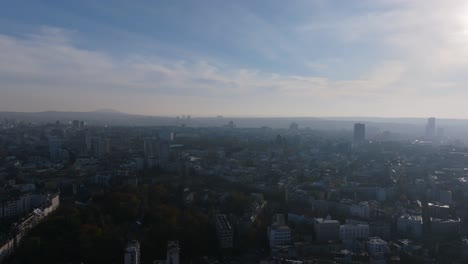 Aerial-flyover-in-the-misty-haze-of-the-morning-of-the-city-of-Belgrade,-Serbia