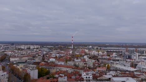 Aerial-footage-of-a-smokestack-chimney-of-an-energy-plant-in-Belgrade,-Serbia-on-a-cloudy-day