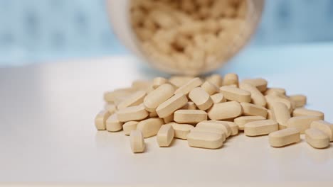 Vitamin-C-Tabletten-Aus-Der-Flasche-Auf-Den-Tisch-Gegossen,-Nahaufnahme-In-Zeitlupe