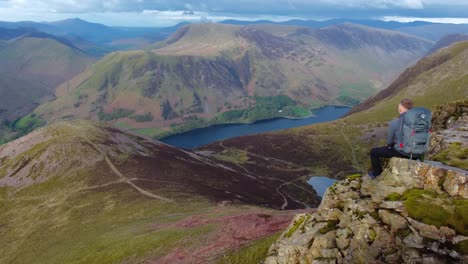 Cinematic-video-of-hiker-sat-enjoying-incredible-views-from-Red-Pike-across-Buttermere-in-the-Lake-District---UK