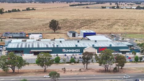 Yarrawonga,-Victoria,-Australia---7-December-2023:-Aerial-approaching-the-Yarrawonga-Bunnings-hardware-store-with-paddocks-and-Yarrawonga-Airport-beyond