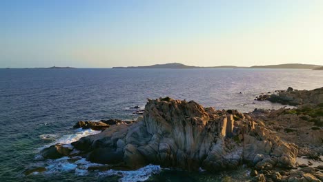 Rotating-left-revealing-a-rugged-Mediterranean-coastline-on-sunny-day