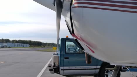 Half-Truck-Tug-Behind-Cessna-Seaplane-At-The-Airfield