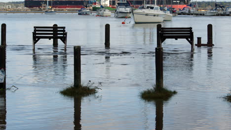 benches-and-pathway-flooded-at-high-tide-at-Ashlett-creek-in-the-Solent,-Southampton