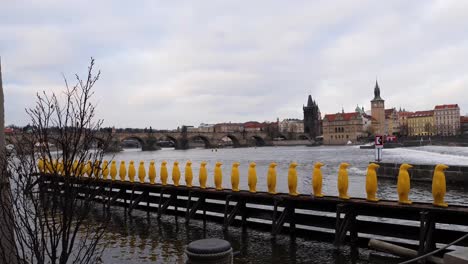 Charles-Bridge,-Yellow-penguins-and-Vltava-river,-Prague,-Czech-Republic