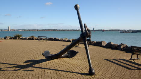 Wide-mid-shot-of-an-old-anchor-at-Hythe-Marina-village-with-Weston-in-background