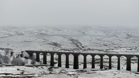 Establishing-Aerial-Drone-Shot-of-Snowy-Yorkshire-Dales-and-Ribblehead-Viaduct-UK