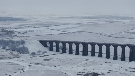Rising-Establishing-Aerial-Drone-Shot-of-Ribblehead-Viaduct-on-Snowy-Day-in-Yorkshire-Dales-UK
