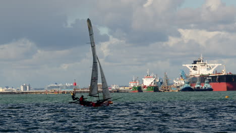Sailor-Trapezing-from-a-Isometric-Sailing-dinghy-at-Calshot-spit,-the-Solent,-Southampton