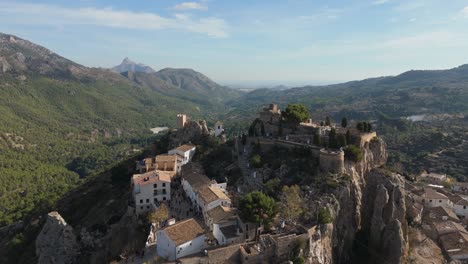 Drone-aproaching-to-the-Castle-of-Guadalest,-which-is-nestled-on-the-top-of-a-rock
