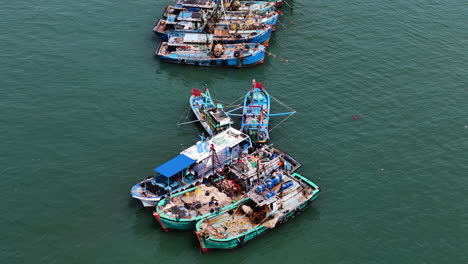 Moored-Vietnamese-fishing-vessels,-aerial-orbit-view